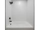Close up of the bathtub, featuring white wavy tile and black hardware at 14903 Winterwind Dr, Tampa, FL 33624