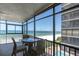 Balcony with chairs and table overlooking beach, ocean, and pool at 15400 Gulf Blvd # 202, Madeira Beach, FL 33708