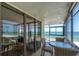 Relaxing condo balcony with chairs and table overlooking the beach at 15400 Gulf Blvd # 202, Madeira Beach, FL 33708