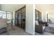Spacious condo balcony features comfortable seating, tile flooring, and sliding glass doors with beautiful ocean views at 15400 Gulf Blvd # 202, Madeira Beach, FL 33708
