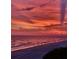 Beautiful sunset over the ocean with people walking on the sandy beach at 15400 Gulf Blvd # 202, Madeira Beach, FL 33708
