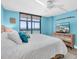 Comfortable bedroom with a king bed, dresser, and beautiful balcony view at 15400 Gulf Blvd # 202, Madeira Beach, FL 33708