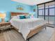 Bedroom with king size bed, nightstands, and a balcony at 15400 Gulf Blvd # 202, Madeira Beach, FL 33708