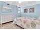 Inviting bedroom featuring a dresser, comfortable bed, and light blue walls at 15400 Gulf Blvd # 202, Madeira Beach, FL 33708