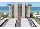 Beachfront condo building with palm trees and covered parking at 15400 Gulf Blvd # 202, Madeira Beach, FL 33708