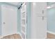 Hallway with extra storage and blue walls next to white doors at 15400 Gulf Blvd # 202, Madeira Beach, FL 33708