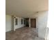 Well-lit hallway with tile flooring leading to various doors and units at 15400 Gulf Blvd # 202, Madeira Beach, FL 33708