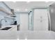 Bright kitchen with white cabinets, marble countertops, and open shelving near the dining area at 15400 Gulf Blvd # 202, Madeira Beach, FL 33708