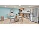 Modern kitchenette features stainless steel refrigerator, coffee bar, and dining table at 15400 Gulf Blvd # 202, Madeira Beach, FL 33708