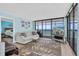 Cozy living room offers ocean views, comfortable seating and seamless flow to the bedroom at 15400 Gulf Blvd # 202, Madeira Beach, FL 33708