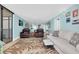 Spacious living room featuring two recliners, a couch, and a sliding glass door at 15400 Gulf Blvd # 202, Madeira Beach, FL 33708