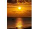 Beautiful sunrise with a boat on the ocean horizon at 15400 Gulf Blvd # 202, Madeira Beach, FL 33708