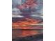 Vibrant beach sunset view with colorful clouds reflecting in the ocean at 15400 Gulf Blvd # 202, Madeira Beach, FL 33708