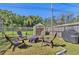 Enjoy the backyard featuring a shed, and seating around a fire pit at 1560 Simmons Dr, Clearwater, FL 33756