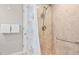Bathroom featuring tiled shower, grab bar, and seashell-themed shower curtain at 1560 Simmons Dr, Clearwater, FL 33756