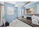 This inviting bathroom features bright blue walls and a vanity with a dark countertop at 1560 Simmons Dr, Clearwater, FL 33756