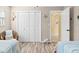 Bedroom featuring two twin beds, wood floors, and nautical themed decor at 1560 Simmons Dr, Clearwater, FL 33756
