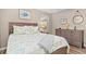 Bedroom featuring wood floors, dresser, and nautical decor at 1560 Simmons Dr, Clearwater, FL 33756