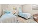 Bedroom featuring two twin beds, wood floors, and nautical themed decor at 1560 Simmons Dr, Clearwater, FL 33756
