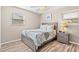 Bedroom with wood floors, two windows, and a ceiling fan at 1560 Simmons Dr, Clearwater, FL 33756