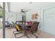 This patio features a dining table, ceiling fan, and beach themed decor at 1560 Simmons Dr, Clearwater, FL 33756