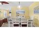 Cozy dining room featuring a glass table, seating for six, and beach-themed decor at 1560 Simmons Dr, Clearwater, FL 33756