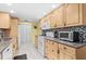 Well-lit kitchen with granite countertops, tile backsplash, and modern appliances at 1560 Simmons Dr, Clearwater, FL 33756