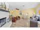 Comfortable living room featuring hardwood floors, a cozy fireplace, and coastal-themed decor at 1560 Simmons Dr, Clearwater, FL 33756