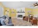 Bright living room with hardwood floors, a cozy fireplace, and comfortable seating at 1560 Simmons Dr, Clearwater, FL 33756