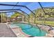 Enjoy the pool and patio in your backyard, surrounded by lush landscaping and secured by a screen enclosure at 1560 Simmons Dr, Clearwater, FL 33756