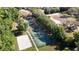 Aerial view of community amenities: tennis courts, basketball court, sand volleyball, providing recreational opportunities at 15625 Hawks Crest Loop, Odessa, FL 33556