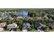 Wide aerial shot shows a scenic neighborhood surrounding a lake at 15625 Hawks Crest Loop, Odessa, FL 33556