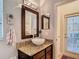 Stylish bathroom featuring granite countertop, vessel sink, and modern lighting fixtures at 15625 Hawks Crest Loop, Odessa, FL 33556