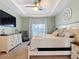 Comfortable bedroom features plush carpet, a tray ceiling, and a neutral color scheme for a serene feel at 15625 Hawks Crest Loop, Odessa, FL 33556