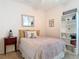 Comfortable bedroom with a cozy bed, decorative shelving, and soft lighting at 15625 Hawks Crest Loop, Odessa, FL 33556