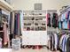 Well-organized walk-in closet featuring shelving, drawers, and hanging rods for clothes and shoes at 15625 Hawks Crest Loop, Odessa, FL 33556