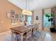 Cozy dining room with wood table and chairs, a chandelier, natural light, and hardwood floors at 15625 Hawks Crest Loop, Odessa, FL 33556