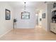 Spacious dining room with elegant chandelier, wood floors, and decorative mirror reflecting light at 15625 Hawks Crest Loop, Odessa, FL 33556