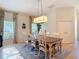 Charming dining room featuring a wooden table with seating for six and stylish chandelier at 15625 Hawks Crest Loop, Odessa, FL 33556