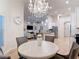 Bright dining area with modern chandelier and views of the living room and stainless kitchen at 15625 Hawks Crest Loop, Odessa, FL 33556