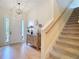 Welcoming foyer features a front door, staircase, and wooden floors, creating a warm entrance at 15625 Hawks Crest Loop, Odessa, FL 33556
