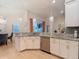 Beautiful kitchen area featuring white cabinets, granite countertops, stainless steel appliances, and hardwood floors at 15625 Hawks Crest Loop, Odessa, FL 33556