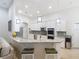 Bright, modern kitchen with stainless steel appliances, granite countertops, and breakfast bar seating at 15625 Hawks Crest Loop, Odessa, FL 33556