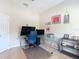 Bright office space featuring a modern desk, multiple monitors, and ample storage at 15625 Hawks Crest Loop, Odessa, FL 33556