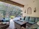 Covered patio featuring cozy seating and a view of the screened-in pool area, creating an ideal outdoor retreat at 15625 Hawks Crest Loop, Odessa, FL 33556