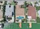 Aerial view showcases this home's backyard, pool, and dock with waterfront access at 16353 Redington Dr, Redington Beach, FL 33708