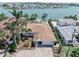 Aerial view of the property featuring a private dock, and tropical landscaping at 16353 Redington Dr, Redington Beach, FL 33708