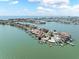 Aerial view of waterfront property on tip of island with private dock, boat lift and bay access at 16353 Redington Dr, Redington Beach, FL 33708