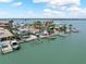 Aerial view of the property with water views, boat dock, and pool at 16353 Redington Dr, Redington Beach, FL 33708