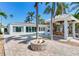 Outdoor entertaining area showcasing a fire pit, pool, gazebo and views at 16353 Redington Dr, Redington Beach, FL 33708